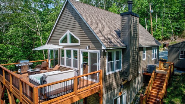 A two-story house with a deck, a hot tub, and a grill. - Lessons from Mars (Banner Elk)