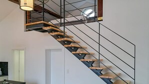 A modern staircase with wooden steps and metal railings, leading to an upper floor. - Gorgeous apartment in Pirovac with WiFi (Pirovac)