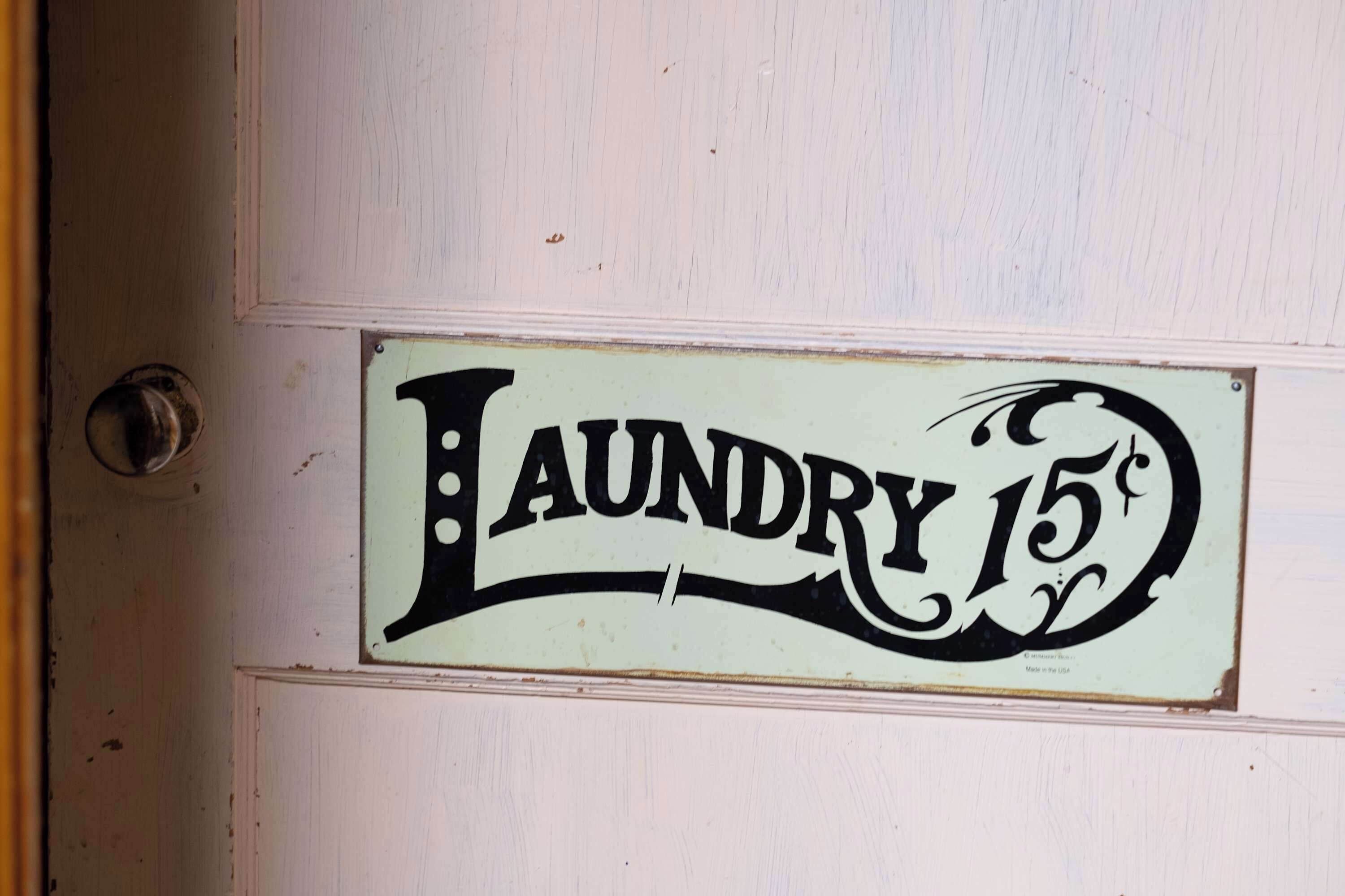 A door with a sign that reads 'Laundry 15¢'.