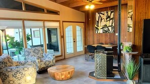 Un interior espacioso con vigas de madera, una chimenea y un comedor.