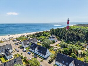 Une ville côtière dotée d’un phare, d’une plage et d’immeubles d’habitation.