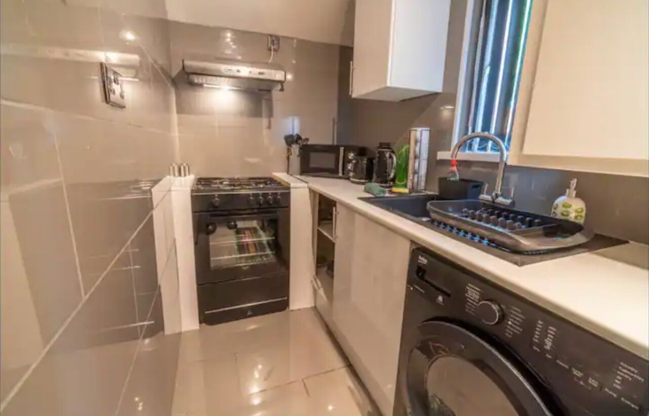 A compact kitchen with a built-in oven, microwave, and dishwasher.