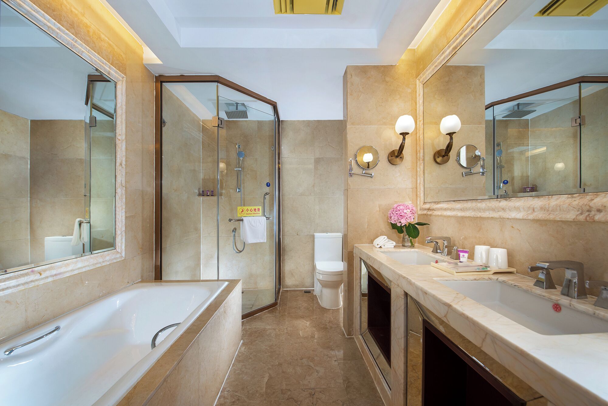 A modern bathroom with a bathtub, shower, toilet, and vanity.