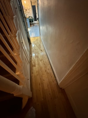 Stylish hallway leading to a room with a door.