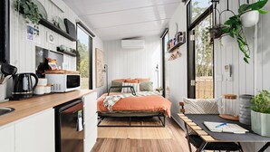 A compact, modern kitchen with a wooden countertop, a microwave, and a coffee maker. - Charmingly Tiny by Tiny Away (Springmount)