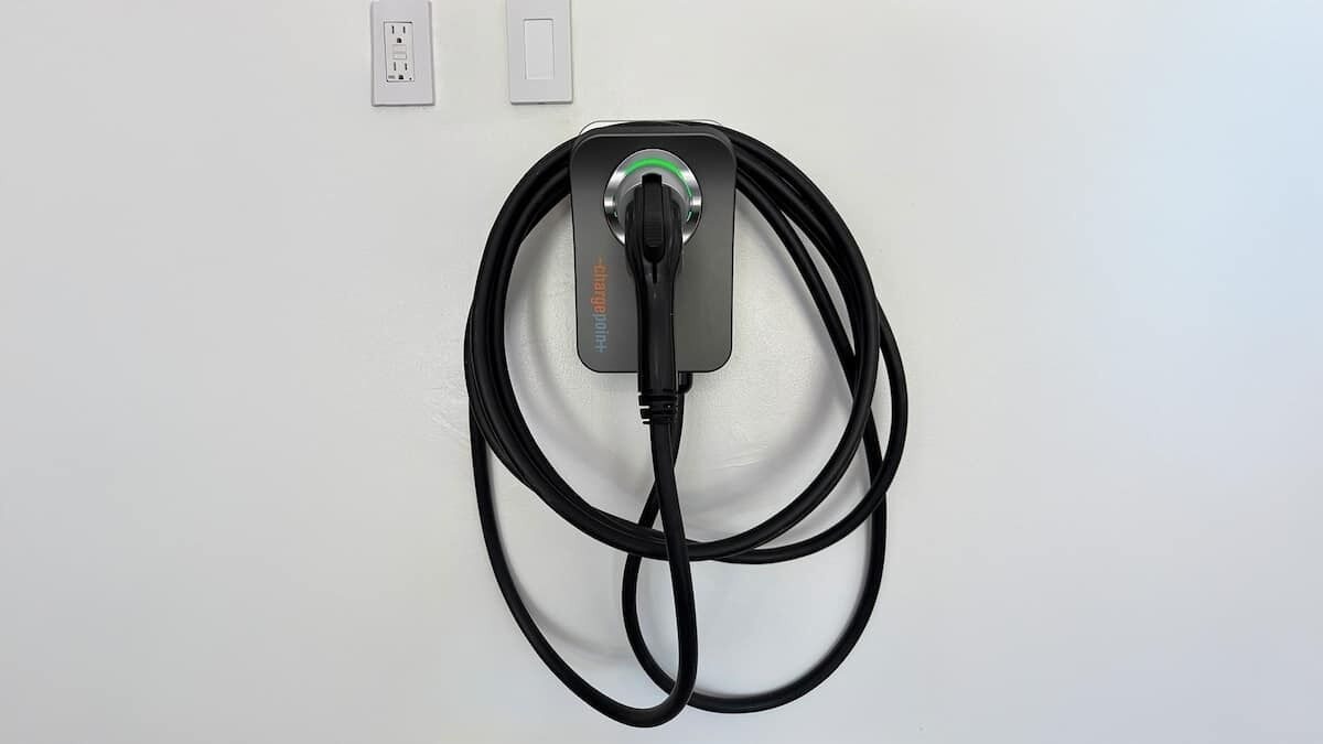 A wall-mounted charging station with a cable.