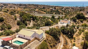 A coastal property with a swimming pool, a detached house, and a view of the sea. - Beach front home in Benajarafe (Benajarafe)