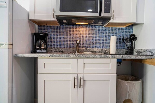 Fridge, microwave, coffee/tea maker, cookware/dishes/utensils