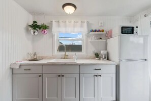 Fridge, microwave, coffee/tea maker, cookware/dishes/utensils