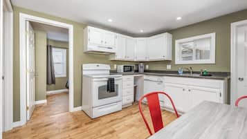 Microwave, dishwasher, coffee/tea maker, dining tables