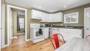 Microwave, dishwasher, coffee/tea maker, dining tables