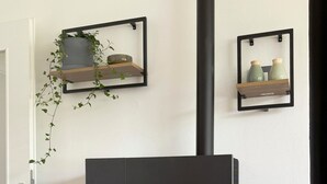 A modern fireplace with a visible fire, a door, and a white wall. - Holiday Home 'Ferienhaus Ahaus' with Private Terrace, Private Garden and Wi-Fi (Ahaus)