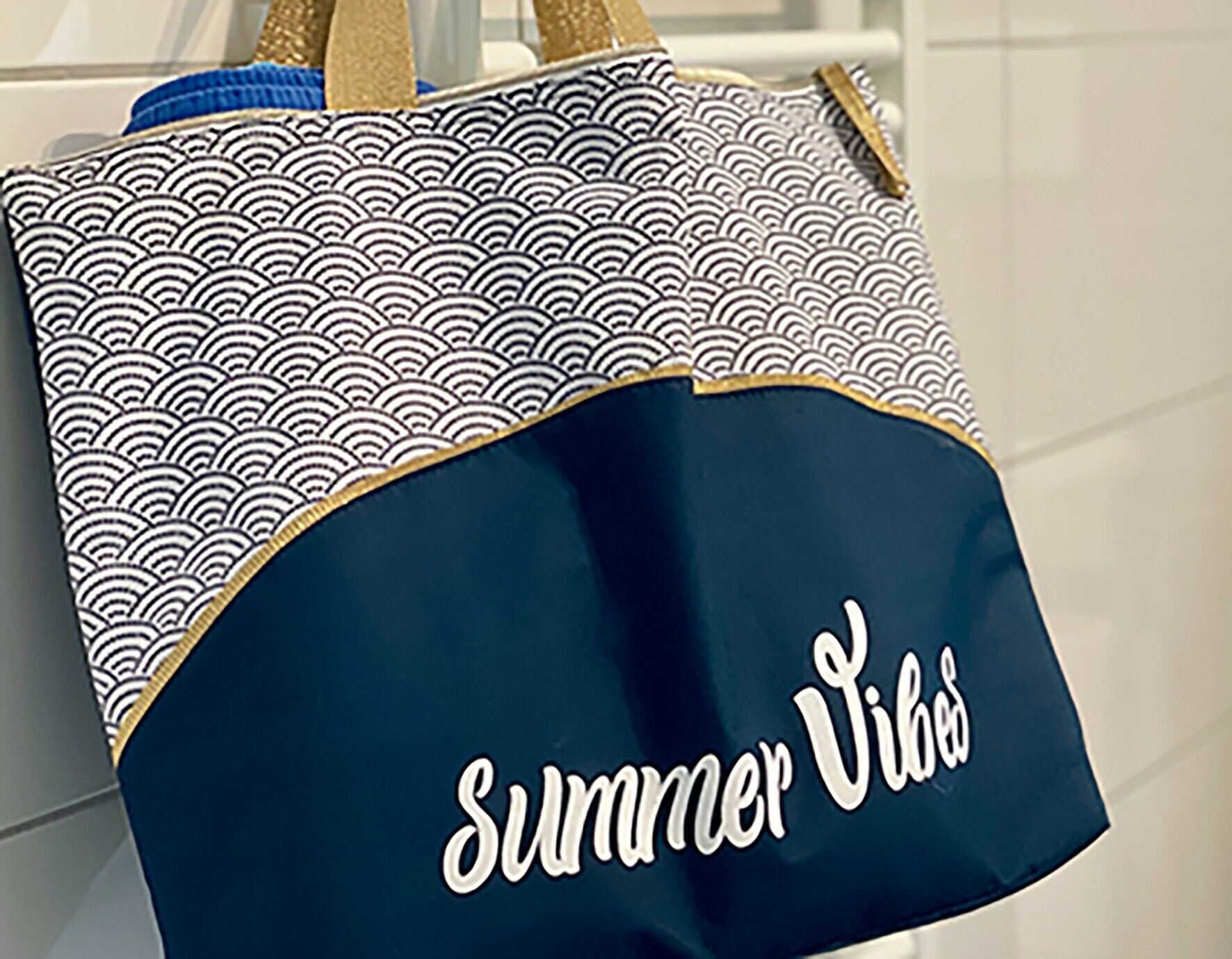 A tote bag with a wave pattern and the text 'Summer Vibes' on it.