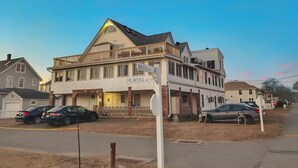 A two-story building with a porch and a sign that reads "Breen's." - The Mast at Soundview · Beach+Ocean+Sunrise (Old Lyme)