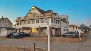A two-story building with a porch and a sign that reads "Breen's." - The Stern at Soundview · Beach+Ocean+Sunrise (Old Lyme)