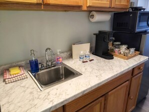 Microwave, coffee/tea maker, cookware/dishes/utensils, spices