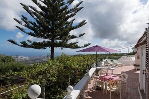 Enjoy a tranquil view of the coastal landscape from this outdoor space.