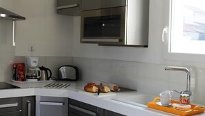 A modern kitchen with stainless steel appliances, a built-in oven, and a window providing natural light. - Villa in Languedoc with Pool near Historic Cities (Rousson)