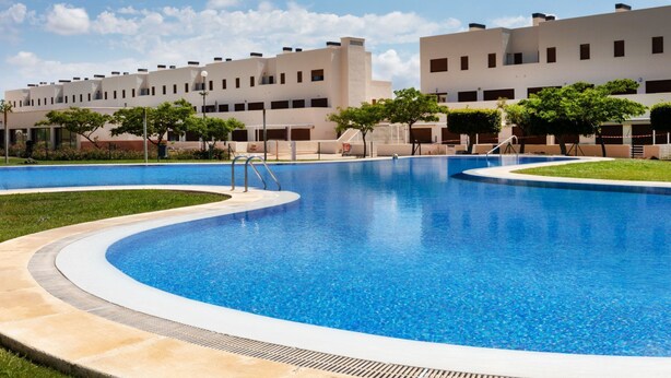 A modern hotel with a large swimming pool, surrounded by well-maintained lawns and trees. - Detinsa by Interhome (Sant Jordi)