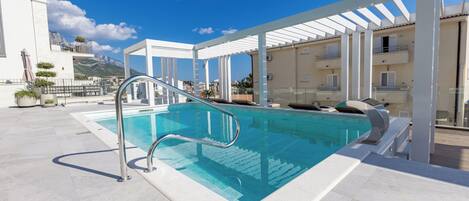 Una piscina al aire libre, una piscina climatizada