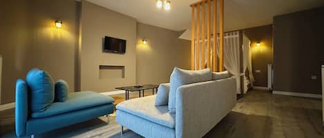 Honeymoon Studio Suite | Living area | 32-inch LED TV with cable channels