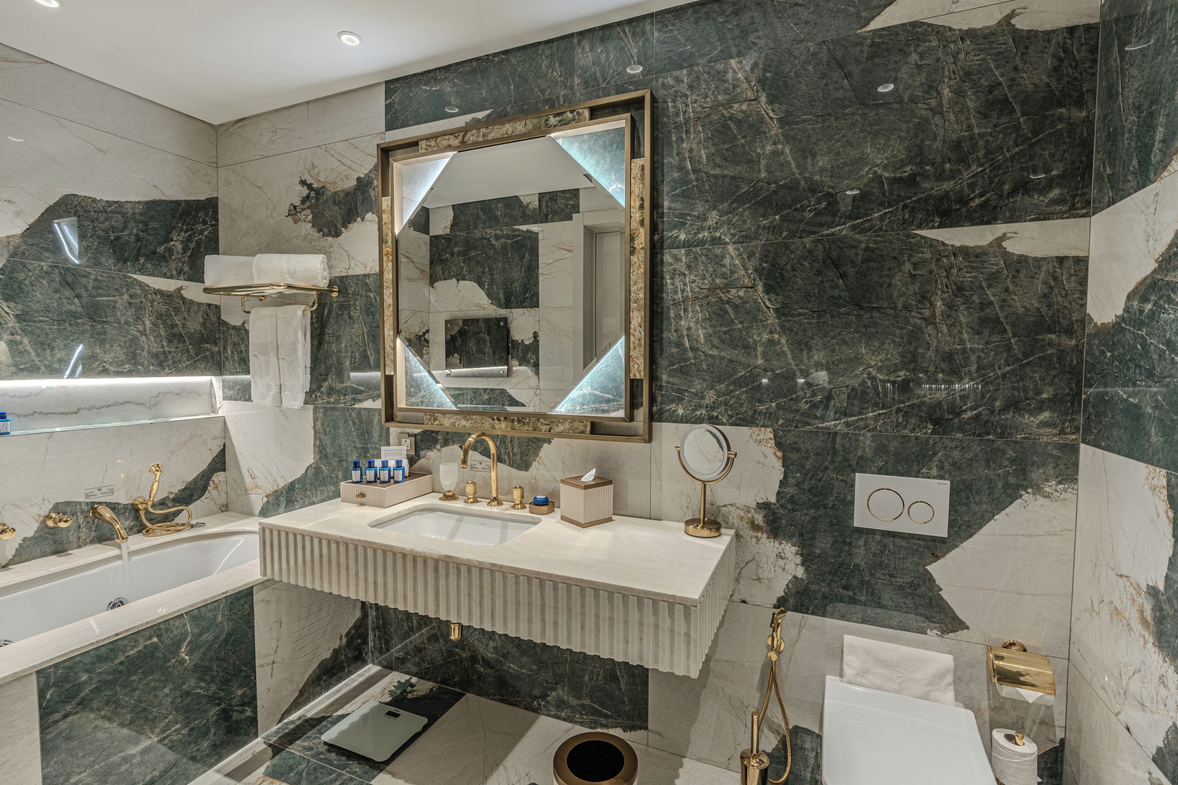 A modern bathroom with a freestanding bathtub, a vanity with a sink, and a large mirror.
