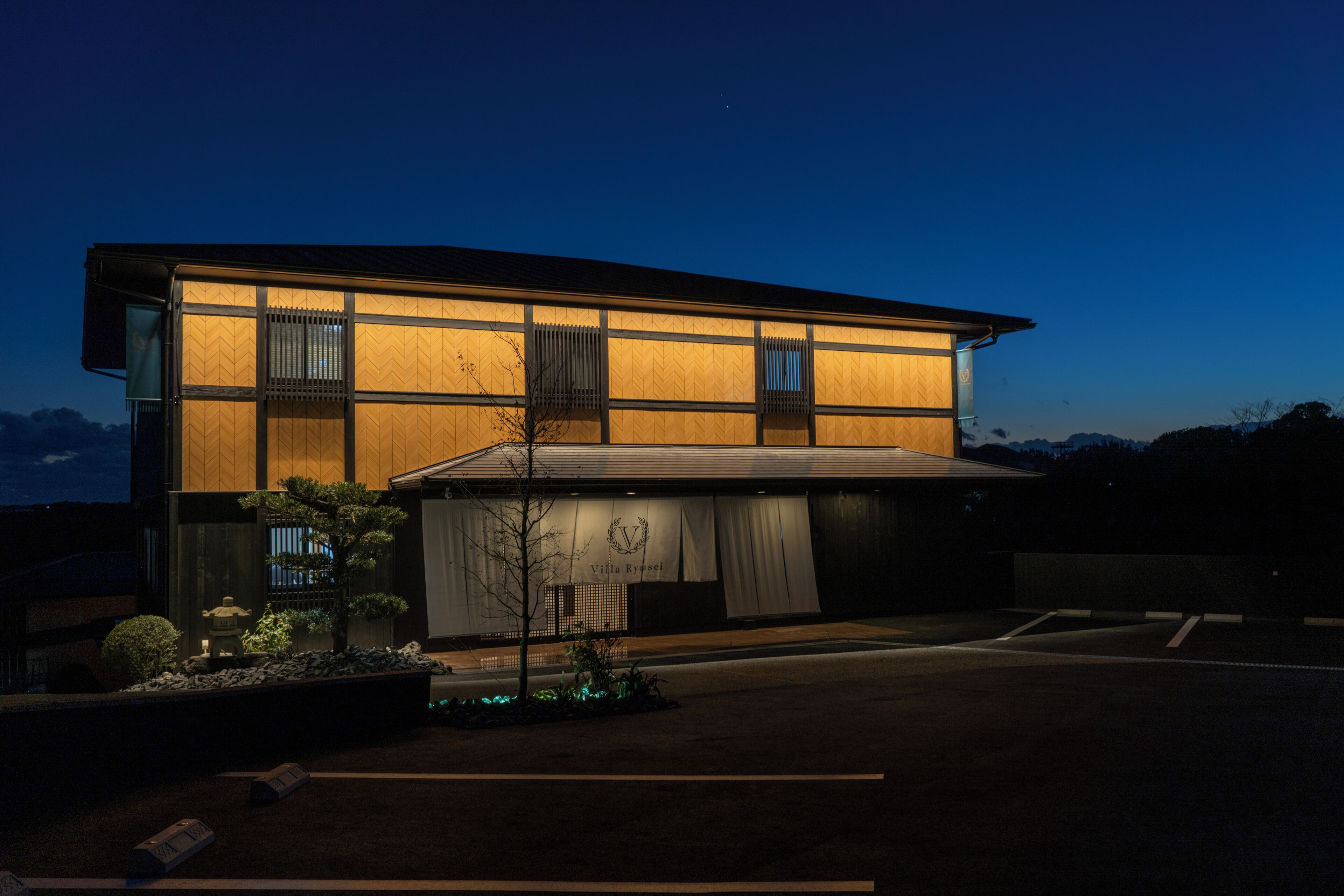 A modern building with a flat roof and large windows.