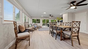 A spacious dining area with a high ceiling, large windows, and a ceiling fan. - "Whitewater-The Main Sail" Oneida Lake/Sleeps 11! (Canastota)