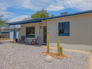A single-story building with a covered porch, a window, and a door. - Sonoran Velo (Tucson)
