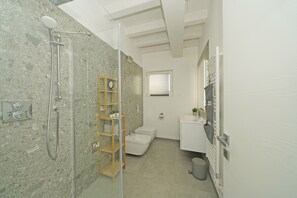 A modern bathroom with a shower, toilet, and vanity. - La Cittadella P1-14 by Wonderful Italy (Manerba del Garda)
