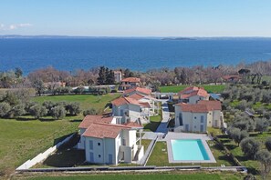 A coastal property with multiple villas, a swimming pool, and a view of the sea. - La Cittadella P1-14 by Wonderful Italy (Manerba del Garda)