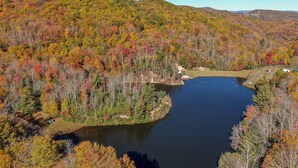 A lake surrounded by autumn-colored trees and hills. - Lake Overlook (Banner Elk)