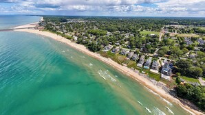 An aerial view of a coastal residential area with houses, a beach, and a bridge. - Trailside Treasure | Pool | Near Lake and Downtown | Hiking & Biking Trail (South Haven)