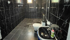A modern bathroom with black marble tiles, a toilet, a sink, and a shower. - Spacious 2bed & 2bath Villa (Bishofitu)