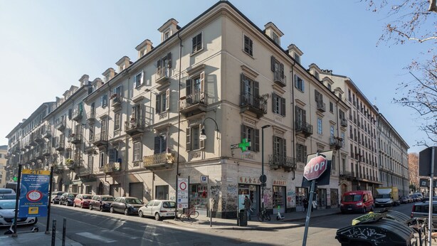 A multi-story building with a classical architectural style, featuring balconies and large windows. - Light Blue Apartment by Wonderful Italy (Turin)