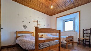 A wooden bunk bed room with a window and a chair. - Cozy Cottage Near Ski Resort and UNESCO Sites, Garden, 3BR, Fully Equipped in Saint-Front (Saint-Front)