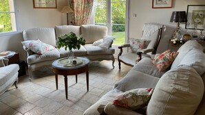 A cozy living room with a sofa set, a side table, and a chair.