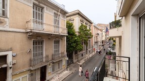 A narrow street lined with historic buildings, featuring balconies and traditional architecture. - Athenian Gate To Plaka (Athens)