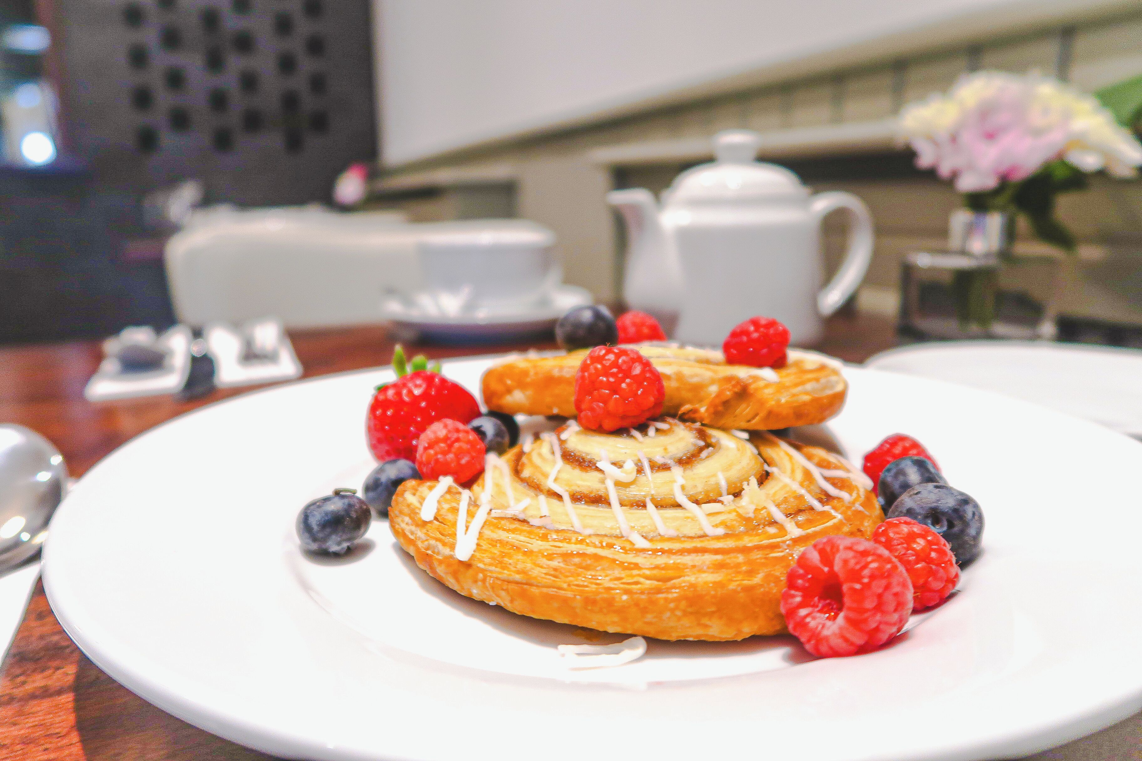A plate with pastries and berries.