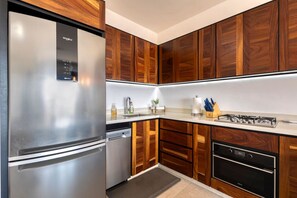 Kitchen features a gas stove, oven, and dishwasher, along with a sink and ample cabinetry.