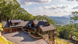 A cabin with multiple rooms, a stone exterior, and a view of the surrounding forest and mountains. - Up and Away at Eagles Nest (Banner Elk)