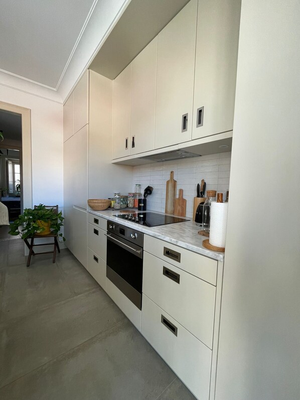 Enjoy cooking in this well-equipped kitchen with an oven, sink, and ample countertop space.