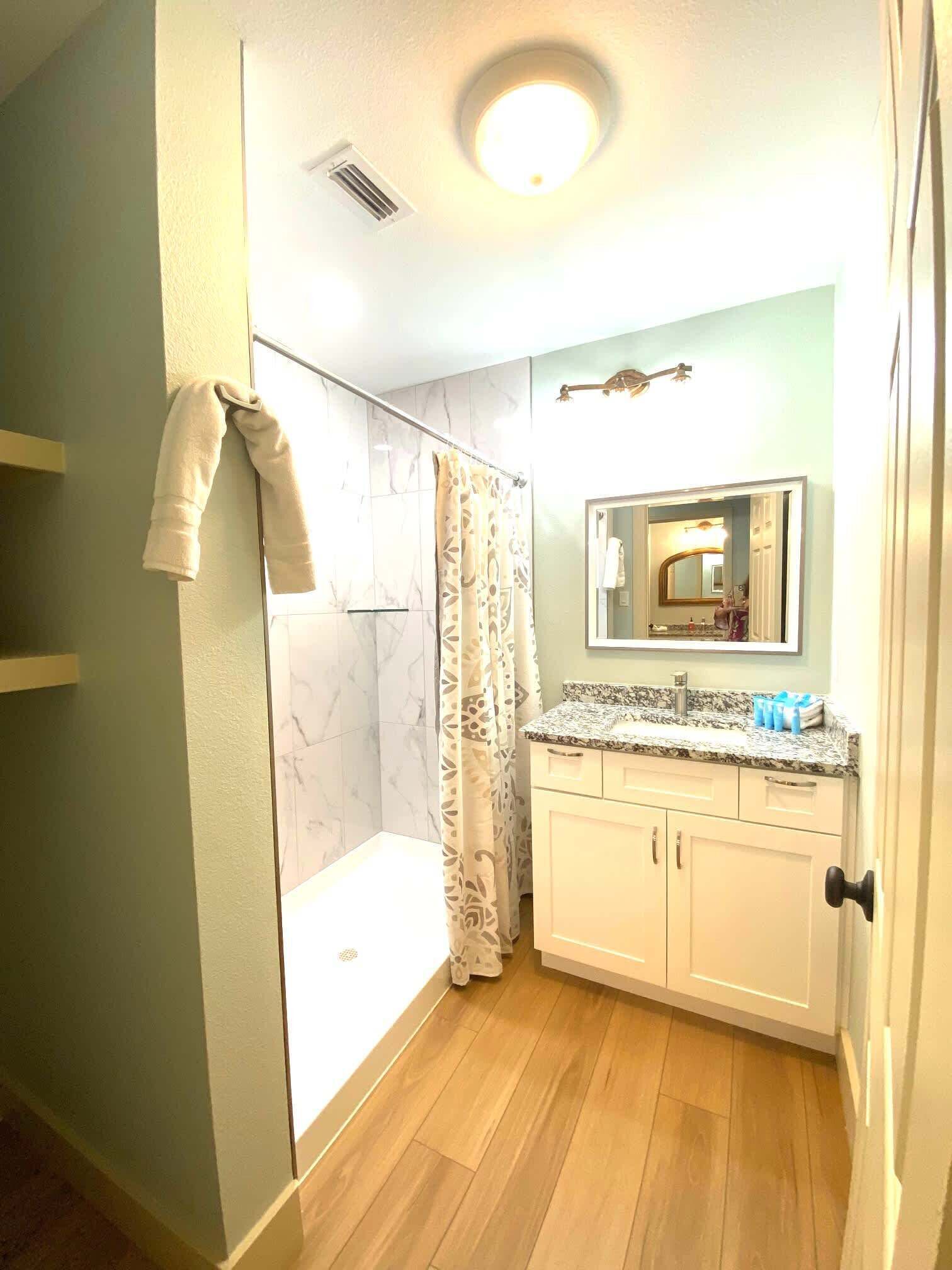 Shower, hair dryer, towels, shampoo