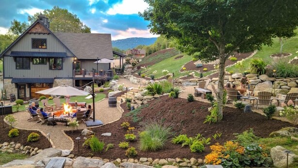 A house with a fire pit, outdoor seating, and a landscaped garden. - Vineyard Vista at Eagles Nest (Elk Park)