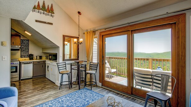A cozy cabin with a kitchen, dining area, and a balcony with a scenic view. - Top Of Seven (Banner Elk)