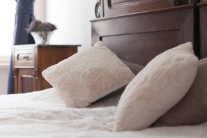 A bed with two pillows and a wooden headboard. - Antique Old Town Apartment (Prague)