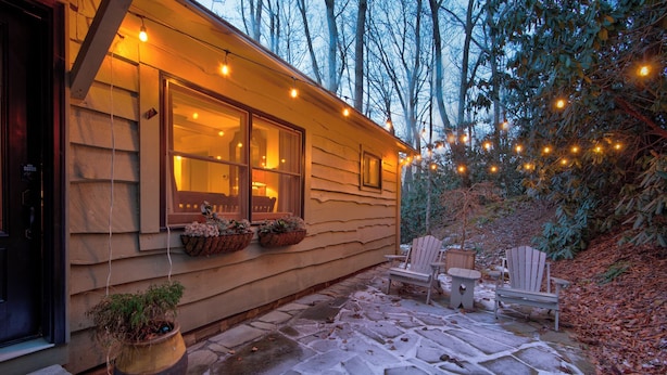 A cozy cabin with a stone patio, wooden deck, and string lights. - Orchid Cabin (Banner Elk)