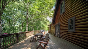 A wooden deck with a rocking chair, picnic table, and barbecue grill. - Atop Boone (Boone)