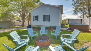 A house with a fire pit in the center surrounded by four chairs. - Saugatuck Dunes Getaway: Pets OK, Hot Tub! (Fennville)