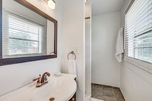 A bathroom with a white sink, a mirror, and a towel rack. - Convenient Punta Gorda Home w/ Patio: Fish & Golf! (Punta Gorda)